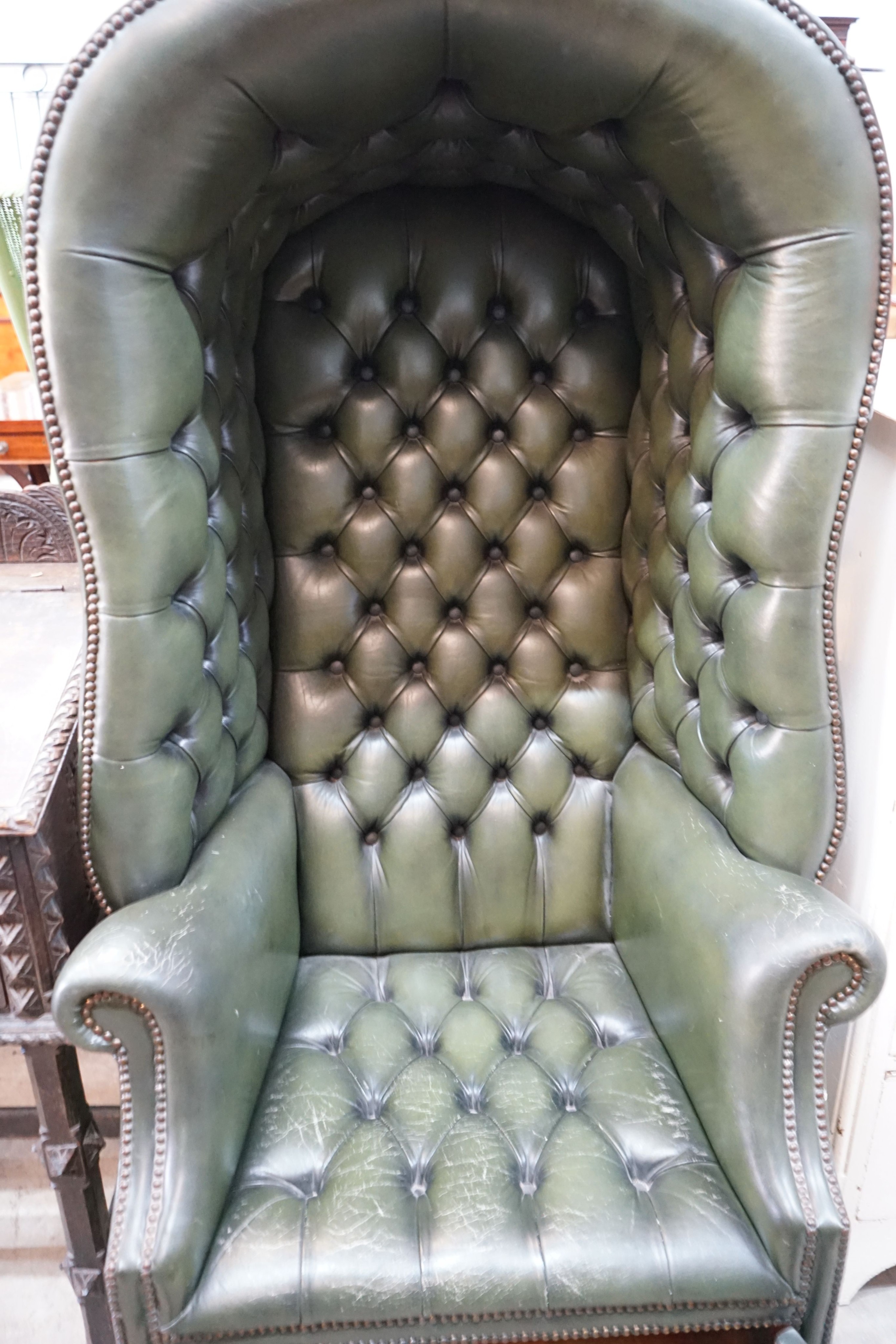 A reproduction buttoned green leather porter's chair, width 82cm, depth 66cm, height 160cm